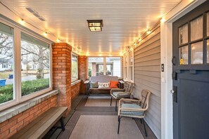Screened Porch: Unwind with friends in this charming space, adorned with twinkling lights and comfy seating.