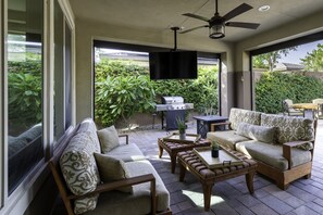 Covered outdoor seating and lounge area with BBQ and Smart TV