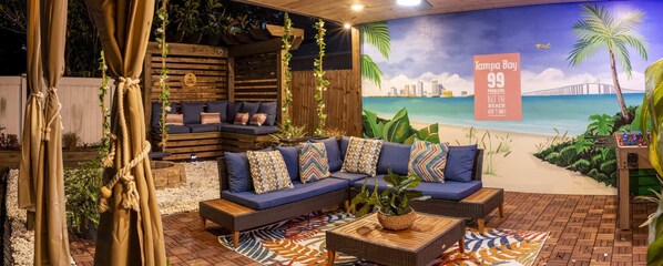 Outdoor living space full with seating, fire pit, Grill, Smart TV, etc.