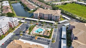 There is a courtyard pool and pool deck with chairs at Majestic Palms