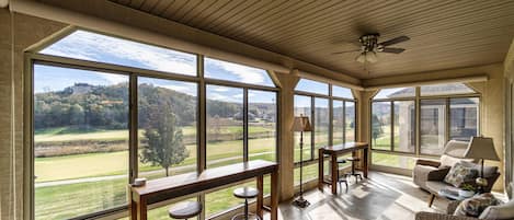 Bright sunroom with a view of the golf course