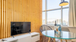 Our living area counts with a dining table for two and a TV for your entertainment #modern #practical