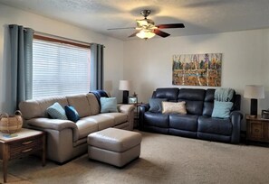 Living room has a TV and is open to the dining area