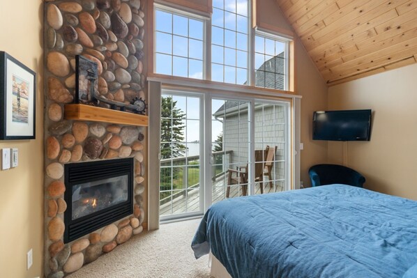 Main Bedroom, with private patio, lake views, and a gas operated fireplace.