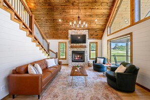 Cozy modern living room with fireplace and leather sofa.