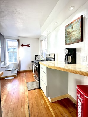 Kitchen and stairs to sitting/sleeping area. 