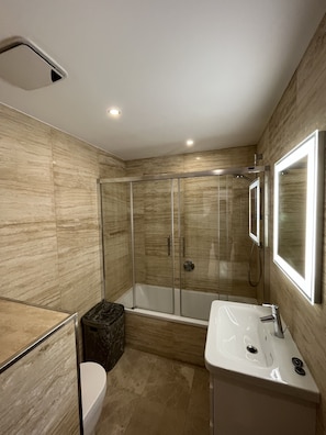 Bathroom; 
- toilet 
- bath with shower head
- sink