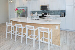 Enjoy our modern kitchen, complete with top-of-the-line appliances and a cozy breakfast island for casual dining.