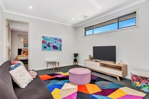 A second living room upstairs creates separate entertaining zones between adults and kids.
