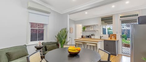 An open plan kitchen and dining area flows out to the fenced backyard with ample seating to enjoy the outdoors.