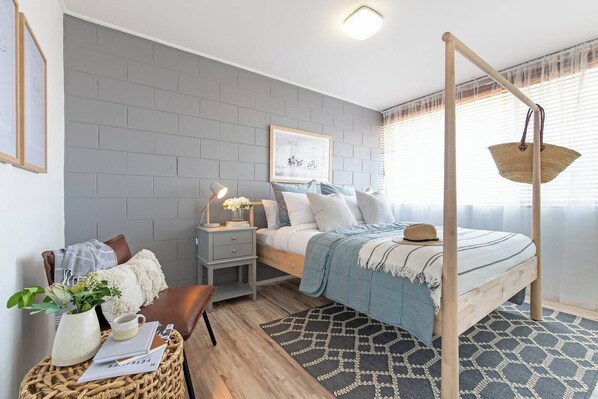 Beautiful, Nordic-inspired primary bedroom is bright and relaxing, complete with a queen-size bed and large built-in wardrobe.