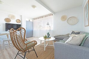 Stepping inside you'll be greeted by a cosy living area fronting a wall-hung TV.‎