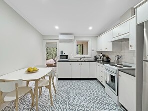 The kitchen is equipped for all your cooking needs, and fitted with a fridge, stove, oven, microwave and coffee maker.