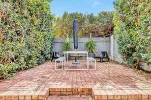 Enjoy dining at home in your sunny private courtyard. There is outdoor seating perfect for sitting down to an alfresco meal.