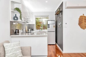 Whip up culinary delights in this well-appointed kitchen, complete with modern appliances for your cooking convenience.