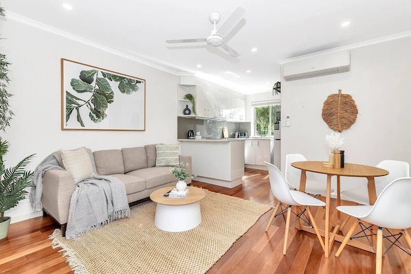 Enjoy the inviting ambiance and ample natural light of the open-plan living area, complemented by a ceiling fan and split-system air conditioning or heating for your comfort.