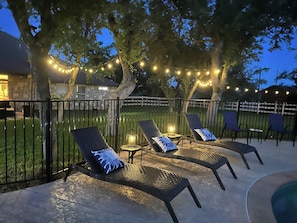 Pool at sunset. Chaise lounge chairs at the pool in the evening...beautiful! 