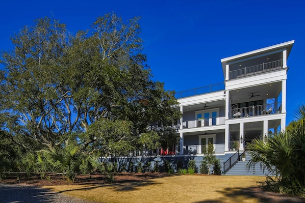 The Porches is an elevated, two story home with two porches and a full roof deck.