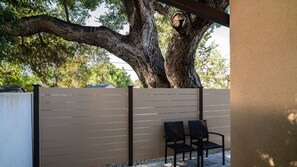 Plenty of shade from a majestic oak tree nestling the private patio