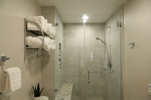 Spa like bathroom fully stocked with toiletries and cleaning supplies