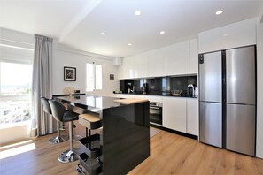 Modern kitchen is fully fitted and has a breakfast bar for two guests