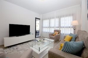 Modern and stylish lounge area with comfortable seating and access to the terrace