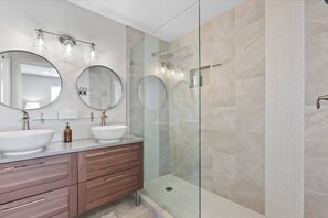 Master bathroom with private toilet, double vanity sink, and walk-in shower.