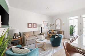 Spacious living room and fully stocked kitchen with dining and island seating