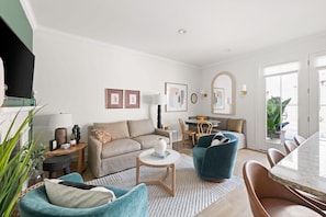 Spacious living room and fully stocked kitchen with dining and island seating