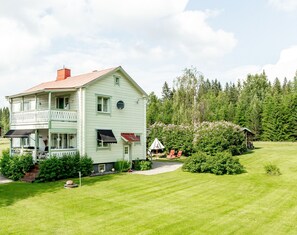 Traditional Swedish house in a beautiful garden adjacent to a wild forest