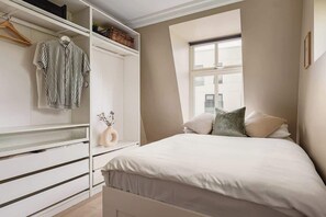 In Bedroom 2, you'll find a comfortable 150cm bed and ample wardrobe space for your belongings.