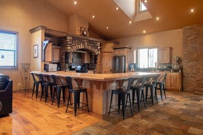 Cook up a storm in this spacious, fully-equipped kitchen. You'll be inspired by the stunning stone accents, ample counter space, and high-end appliances, making meal preparation a true delight for any chef or foodie.