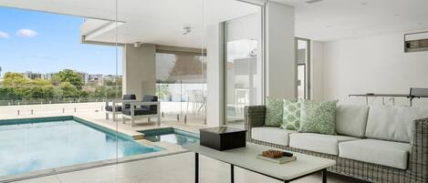 A family room off the pool area houses a ping pong table, lounge and other games to play with the family.