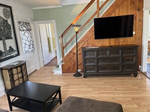 Main living room with Smart TV and stairs to2nd floor