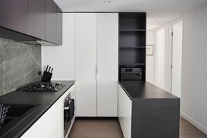 A modern culinary haven awaits you in the fully-equipped kitchen, boasting premium appliances and ample benctop space to inspire your inner chef.