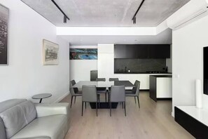 Gather around the spacious six-seater dining table for a delightful home-cooked meal or use it as a workspace for those last-minute emails.