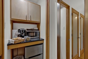 Mini fridge, microwave and coffee maker.
