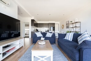 An inviting, open layout is thoughtfully appointed with sliding glass doors leading out the balcony and down to the outdoor dining area.   
