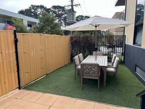 A private outdoor terrace is complete with a BBQ and an outdoor setting for laidback alfresco dining. 
