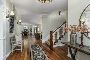 Our home is an open concept home. Hallway leading to great room, kitchen, and dining area. This space is ideal for families and friends to bond and have great conversations.