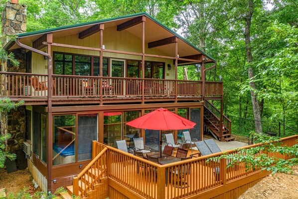 Side exterior with deck seating and outdoor eating area at Buena Vista Getaway, 3 bedroom cabin rental located in Gatlinburg