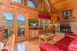 Living room with fireplace and TV at Cupid's Crossing, a 1 bedroom cabin rental located in Pigeon Forge