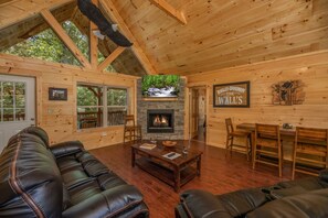 Living room with fireplace and TV at Gar Bear's Hideaway, a 3 bedroom cabin rental located in Pigeon Forge