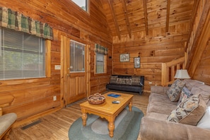 Seating in a living room at Honeymoon in Gatlinburg, a 1 bedroom cabin rental located in Gatlinburg