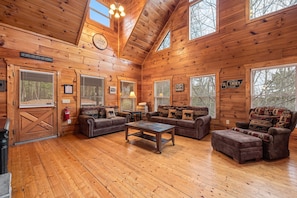 Sofa and chair in the living room at Moonshine Memories, a 2 bedroom cabin rental located in Gatlinburg