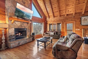TV, fireplace, and views from the living room at Mountain Mama, a 3 bedroom cabin rental located in Pigeon Forge