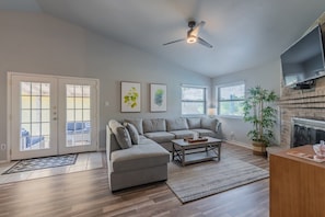 Main living room area w/ large TV & fire place