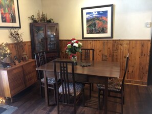 Sturdy antique dining room table. Artwork by Blowing Rock artist Wesley Waugh
