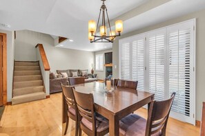 The light-filled living/dining/kitchen area boasts an open layout that blends the spaces seamlessly together.