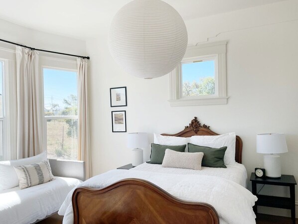 Unwind in Bedroom 1 with a view of the front pasture. This room sleeps 3 with a queen-size bed and a twin daybed.